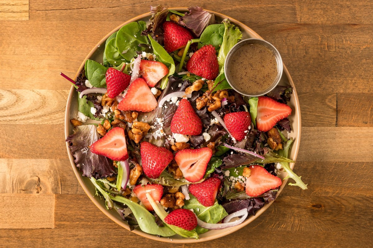 Salad topped with strawberries