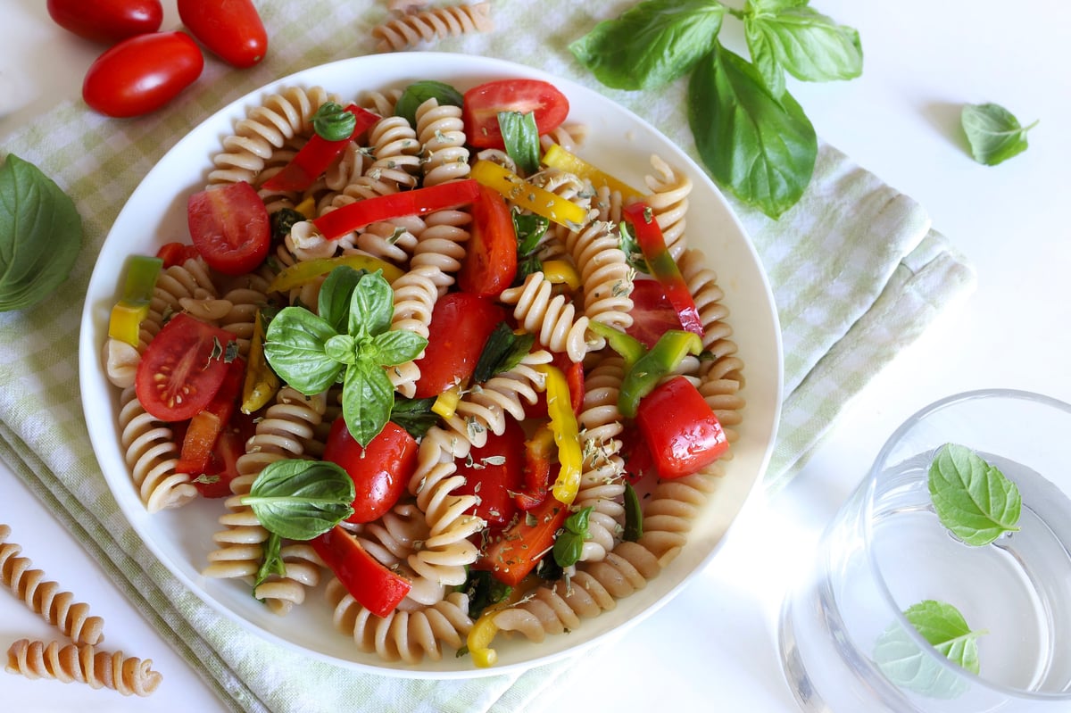 Whole wheat pasta salad with peppers, tomatoes and basil