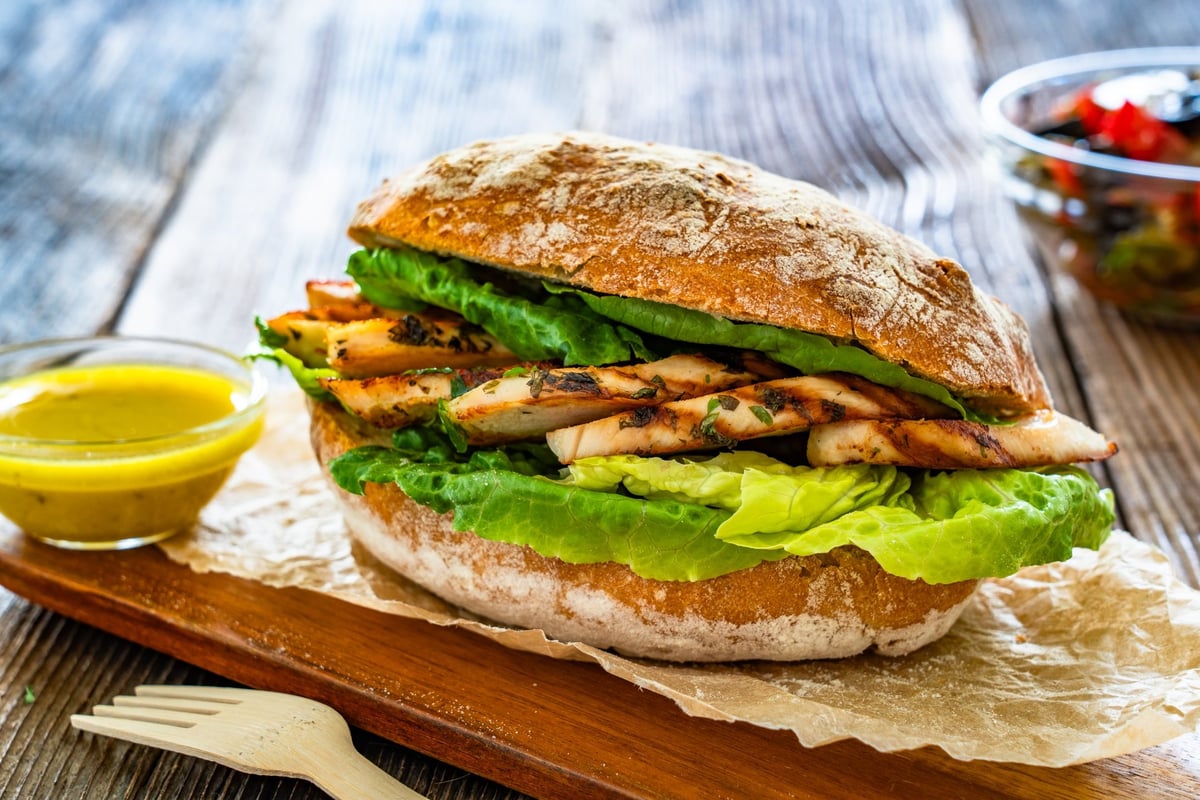Takeaway sandwich with slices of grilled chicken breast
