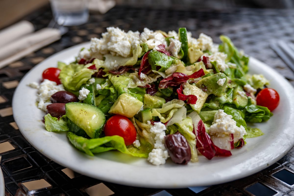 A classic Greek salad with lettuce, cucumber, tomato, feta cheese, and kalamata olive