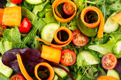 Seasonal spring salad with fresh leafy greens and young vegetables